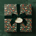 Square gift wrapped in elegant floral wrapping paper with dark green velvet ribbon.