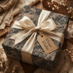 Elegant floral wrapping paper with ivory satin ribbon and "Warm Wishes" tag.