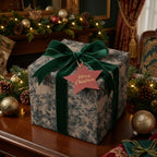 Elegant Christmas gift wrap with a green velvet ribbon and a floral pattern.
