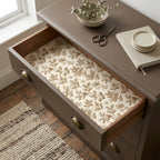 Vintage botanical wrapping paper used as a drawer liner in a rustic dresser, by Wrapped Studios.