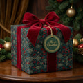 Luxury Christmas gift wrap with vintage green floral pattern and red velvet bow by Wrapped Studios.