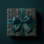 Luxury Christmas wrapping paper with botanical berries and a satin bow by Wrapped Studios.