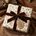 Vintage botanical wrapping paper with a luxury brown velvet ribbon on a gift box by Wrapped Studios.