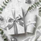 Luxury white and silver floral wrapping paper with satin bows on marble, by Wrapped Studios.