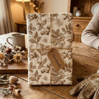 Rustic vintage botanical wrapping paper with twine and a handmade gift tag by Wrapped Studios.