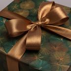 Close-up of a gift wrapped in modern floral wrapping paper with a bronze satin ribbon, ideal for birthdays or Christmas.