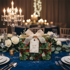 Elegant Christmas gift wrap with holly berry pattern, tied with cream ribbon and "With Love" tag, on blue table setting.