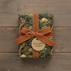 Gift wrapped in elegant floral wrapping paper, tied with a copper ribbon and "Wrappled Studios" tag.