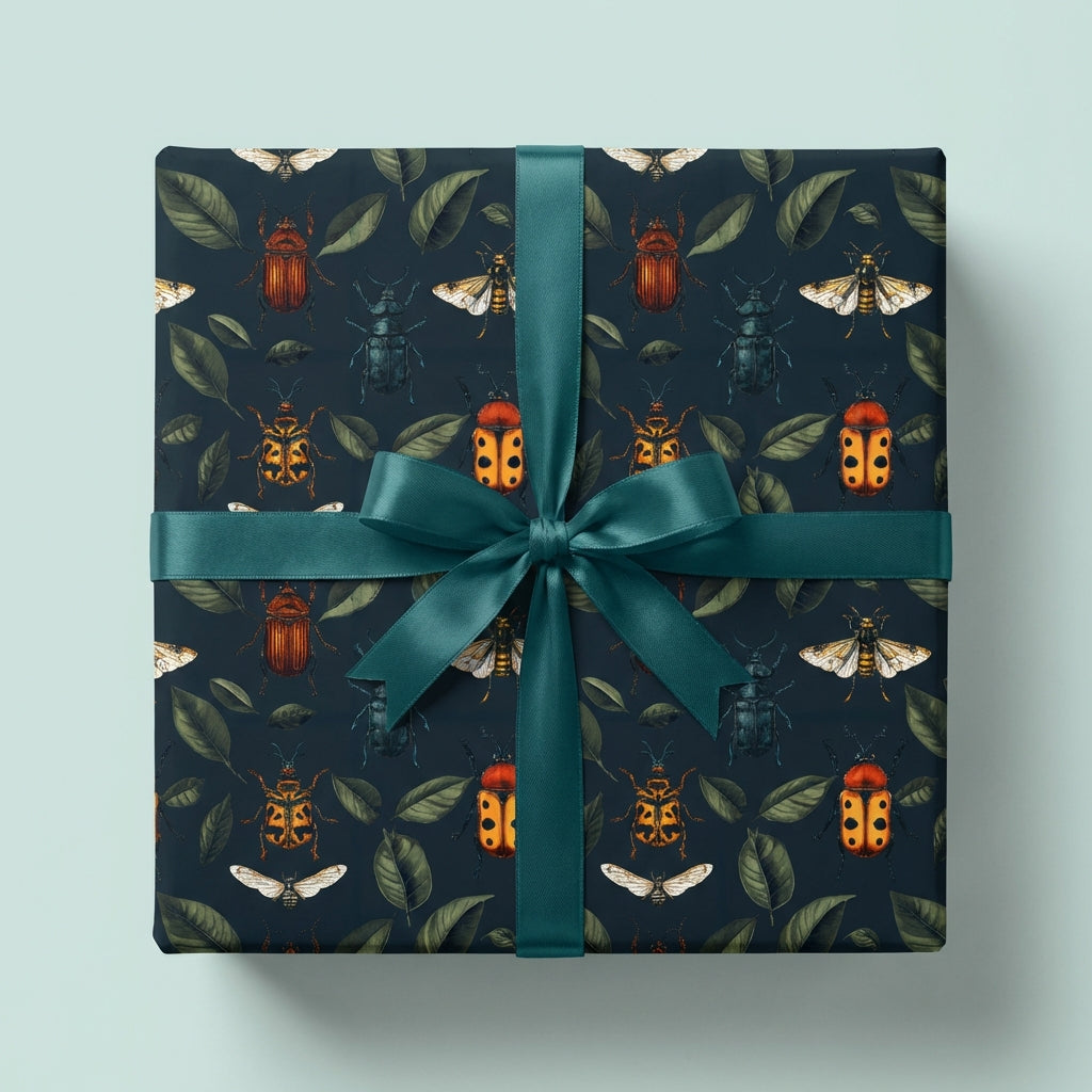 Square gift wrapped in beetle-themed wrapping paper with a teal ribbon.