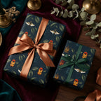 Elegant gift wrap: Navy wrapping paper featuring beetle and leaf pattern, tied with bronze and green satin ribbons.