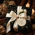Elegant gift wrapped in floral library wrapping paper with a white satin bow and "With Love" tag.
