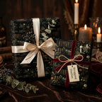 Elegant gifts wrapped in botanical library wrapping paper with ribbons and candles.