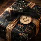 Masculine "For Him" gift wrapped in bookshelf-print wrapping paper with burlap bow and twine.