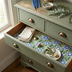 Hanukkah wrapping paper with Star of David and botanical pattern lining a drawer by Wrapped Studios.
