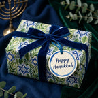 Luxury Hanukkah gift wrap with botanical Star of David pattern and blue velvet ribbon by Wrapped Studios.