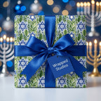Hanukkah wrapping paper with Star of David leaf pattern, blue satin bow by Wrapped Studios.