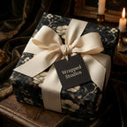 Wrapped Studios luxury gift beautifully wrapped in dark floral wrapping paper with a creamy ribbon.