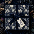 Elegant floral wrapping paper in navy with velvet ribbon bow, perfect for birthday gift wrap or botanical themed gifts.