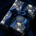 Elegant floral wrapping paper in navy and cream with a satin navy ribbon.