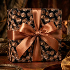 Elegant black and copper botanical luxury gift wrap with a satin bow by Wrapped Studios.