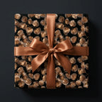 Elegant black and gold floral wrapping paper with a bronze satin bow by Wrapped Studios.