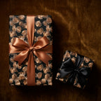 Luxury black and gold botanical wrapping paper with elegant satin bows by Wrapped Studios.