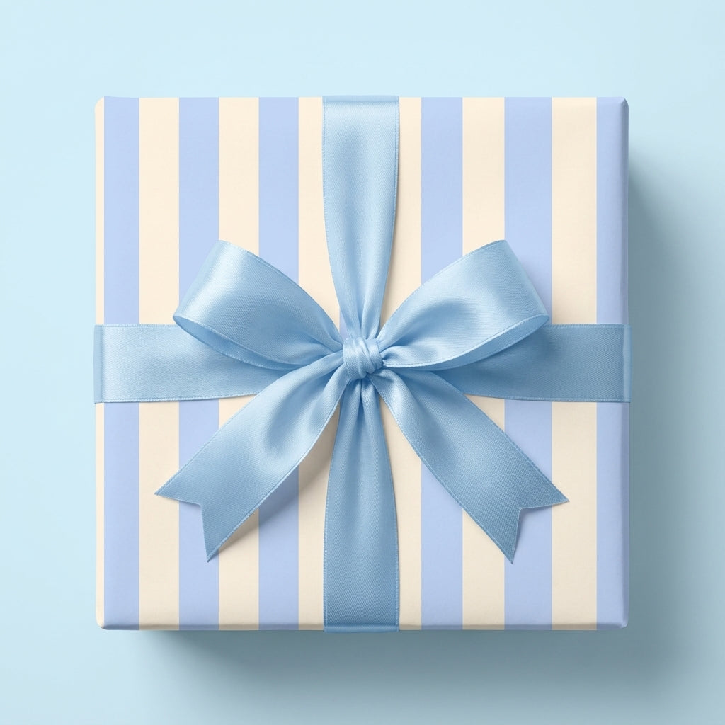 Blue striped wrapping paper with a satin ribbon bow for baby shower gifts by Wrapped Studios.
