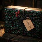 Elegant Christmas gift wrap from Wrapped Studios features a berry and vine pattern with twine and an "Open Me" tag.