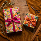 Vibrant botanical floral wrapping paper with luxury satin bows for birthday gifts by Wrapped Studios.