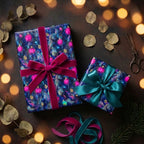 Luxury blue Christmas wrapping paper with pink ornament pattern and velvet bows by Wrapped Studios.