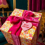 Retro floral wrapping paper gift with pink velvet ribbon and "Love Always" tag. Wrapped Studios.