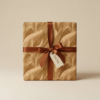 Gift box wrapped in neutral abstract wrapping paper with a brown satin ribbon and "For You" tag.