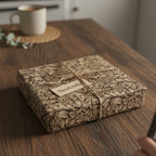 Rustic floral wrapping paper on a gift box with twine and a "handcrafted" tag, perfect for a unique birthday present.