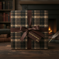 Elegant gift box wrapped in brown plaid wrapping paper with a satin ribbon and tag.