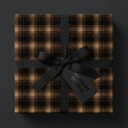 Square gift wrapped in brown plaid paper with black ribbon and bow.
