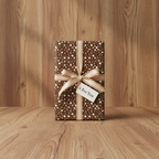 Brown dotted wrapping paper with a gold ribbon and "For You" tag.