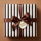 Luxury brown and white striped wrapping paper with a brown satin bow and Wrapped Studios gift tag.