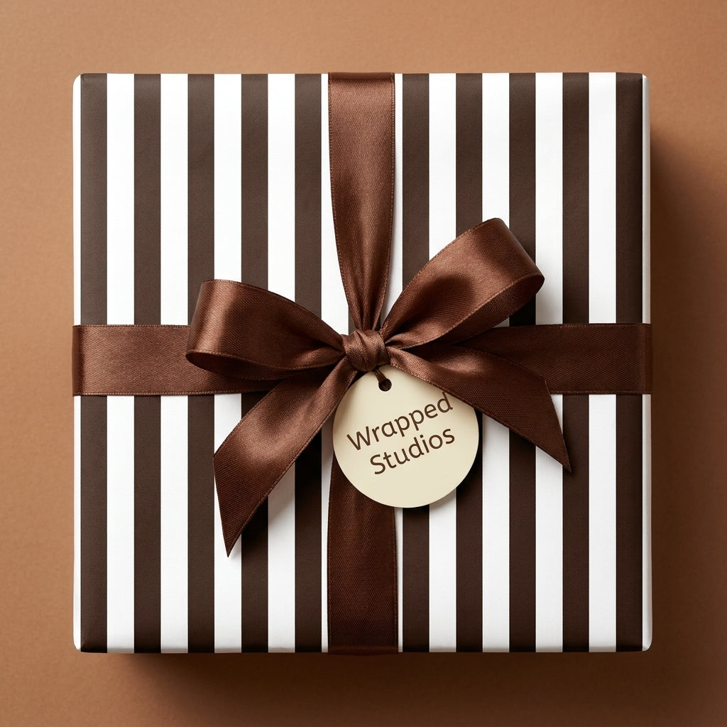 Luxury brown and white striped wrapping paper with a brown satin bow and Wrapped Studios gift tag.