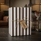 Rustic brown and white striped wrapping paper with a twine bow and Cheers tag, by Wrapped Studios.