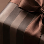 Luxury brown striped wrapping paper with a satin ribbon bow by Wrapped Studios.