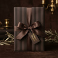 Elegant brown striped wrapping paper with matching luxury satin ribbon and Wrapped Studios tag.