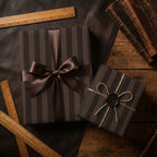 Luxury brown striped wrapping paper with a satin ribbon and wax seal by Wrapped Studios.