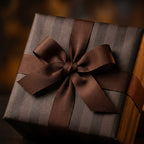 Luxury brown striped wrapping paper with a matching ribbon bow on a gift box, by Wrapped Studios.