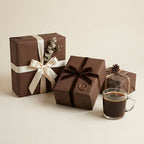 Elegant brown wrapping paper on gifts with silk, velvet, and twine ribbons, plus a mug of coffee.