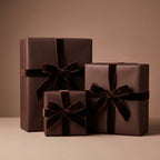Elegant gifts wrapped in solid brown wrapping paper and velvet ribbons for birthdays or special occasions.