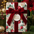 Elegant Christmas gift wrap from Wrapped Studios with ornament pattern and red velvet ribbon.