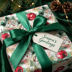 Elegant Christmas gift wrap featuring watercolor ornament design and a green satin ribbon.