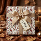 Elegant autumn leaf wrapping paper with gold ribbon and tag by Wrapped Studios.