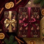 Luxury burgundy Christmas gift wrap with gold ornament patterns and satin bows by Wrapped Studios.