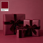 Elegant burgundy wrapping paper on gifts with velvet ribbon bows for Christmas or birthdays.